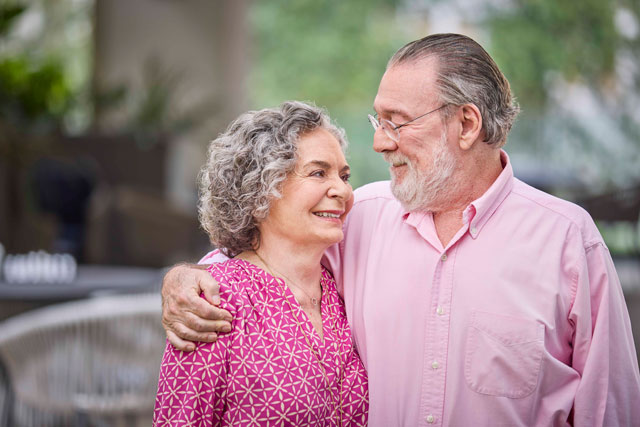 A senior couple enjoys a moment together on the Belmont Village property.